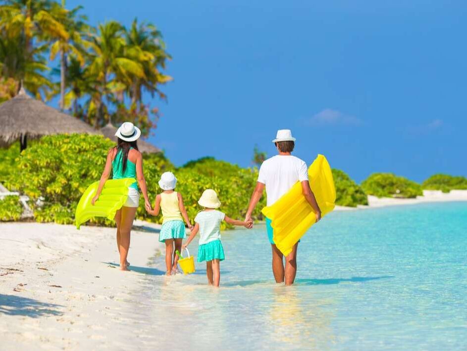 Family of four walking on the beach